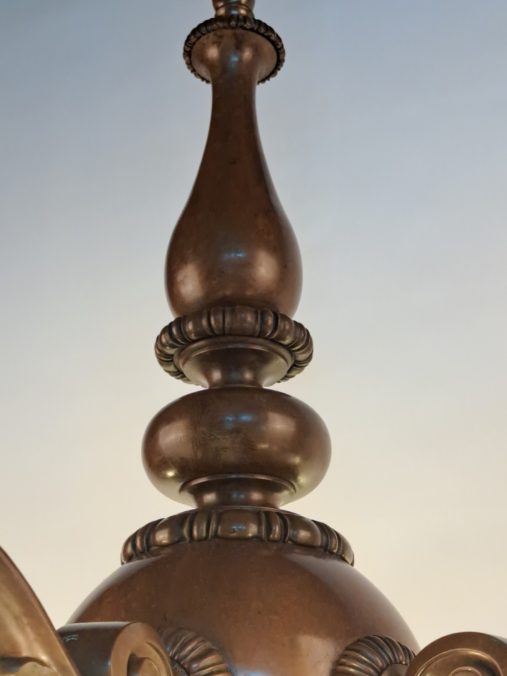 A five-arm dark bronze chandelier featuring a central turned stem, curved scroll arms, and downward-facing frosted glass shades. View XIII