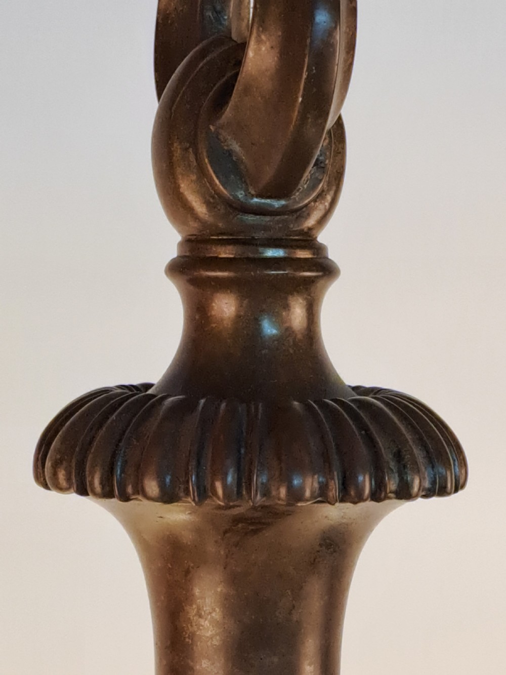 A five-arm dark bronze chandelier featuring a central turned stem, curved scroll arms, and downward-facing frosted glass shades. View XVII