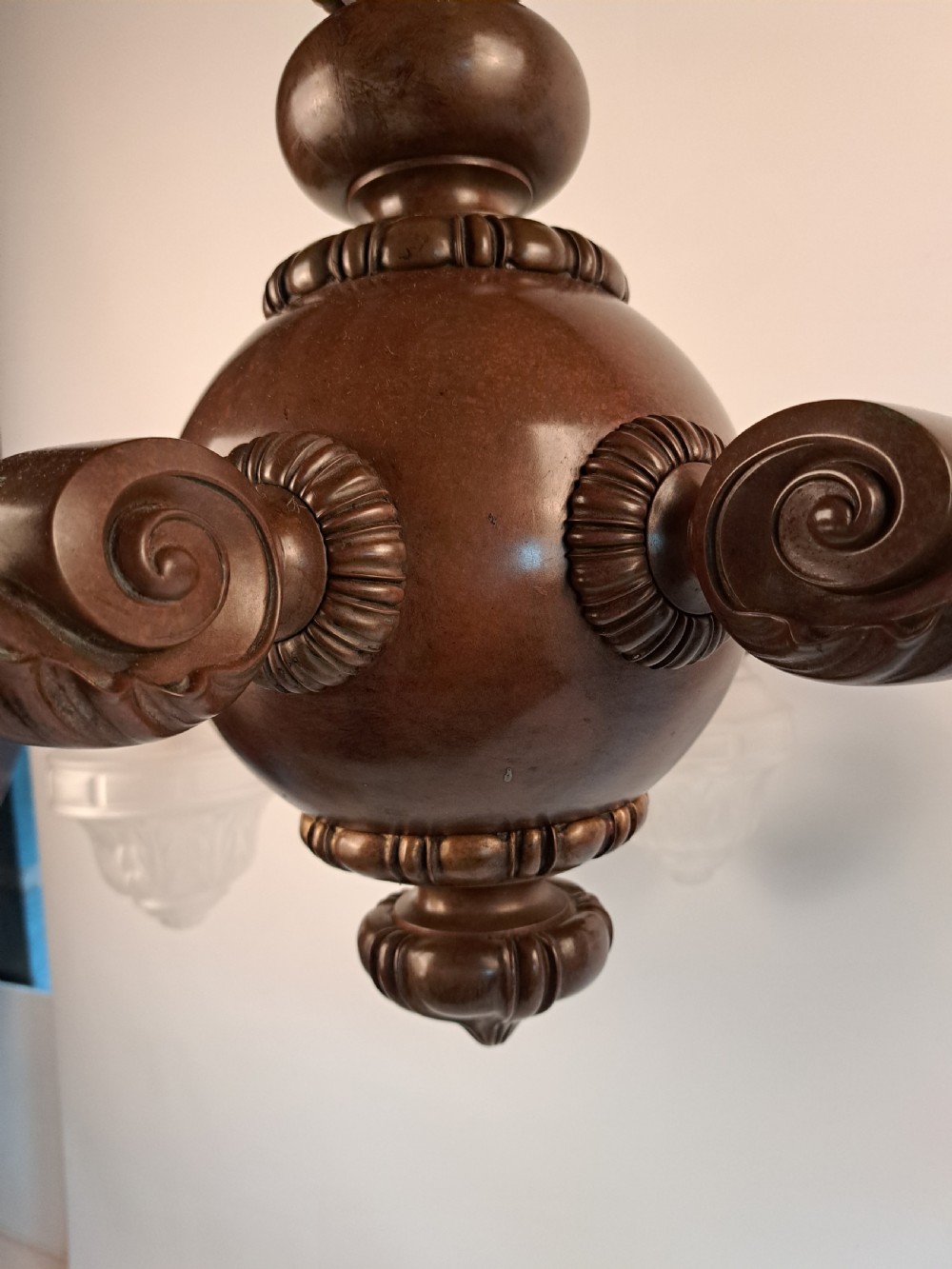 A five-arm dark bronze chandelier featuring a central turned stem, curved scroll arms, and downward-facing frosted glass shades. View XXI