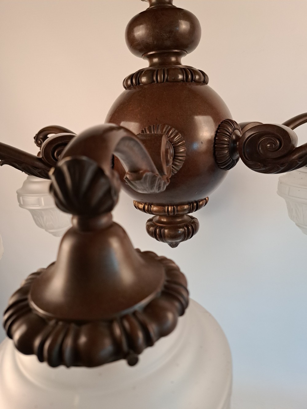 A five-arm dark bronze chandelier featuring a central turned stem, curved scroll arms, and downward-facing frosted glass shades. View XXVII