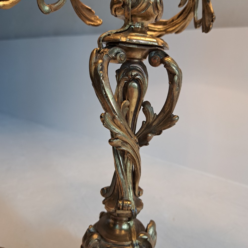 An ornate four-light gilt bronze candelabra table lamp in Rococo Revival style with flared fabric shades and cast scrollwork. View IV