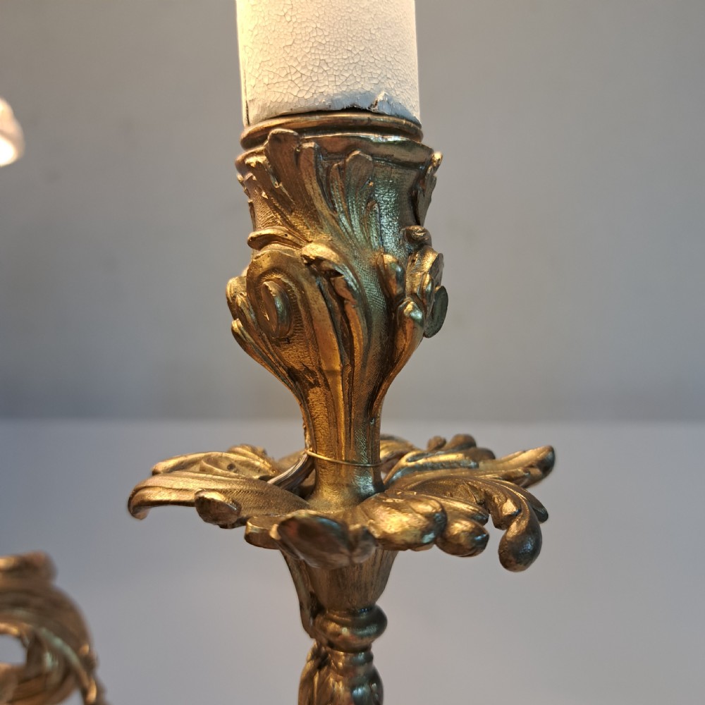An ornate four-light gilt bronze candelabra table lamp in Rococo Revival style with flared fabric shades and cast scrollwork. View VII