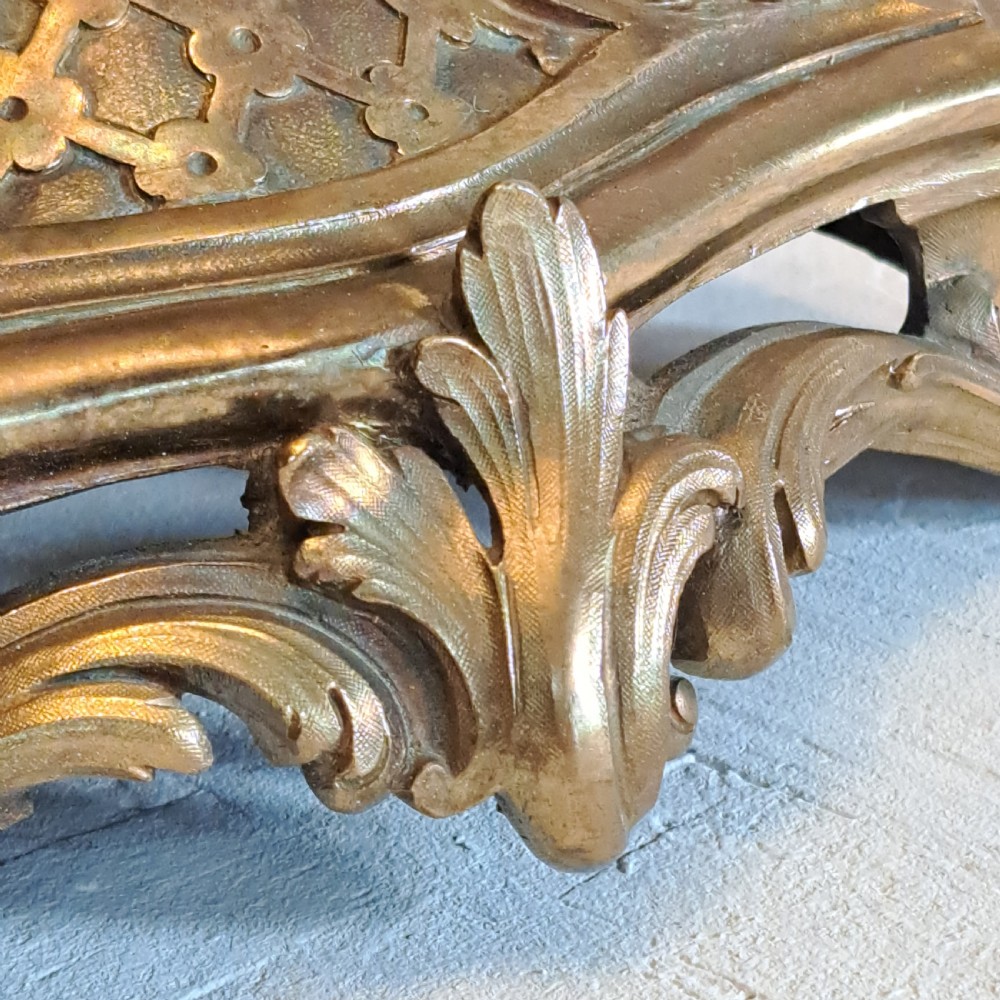 An ornate four-light gilt bronze candelabra table lamp in Rococo Revival style with flared fabric shades and cast scrollwork. View XIV