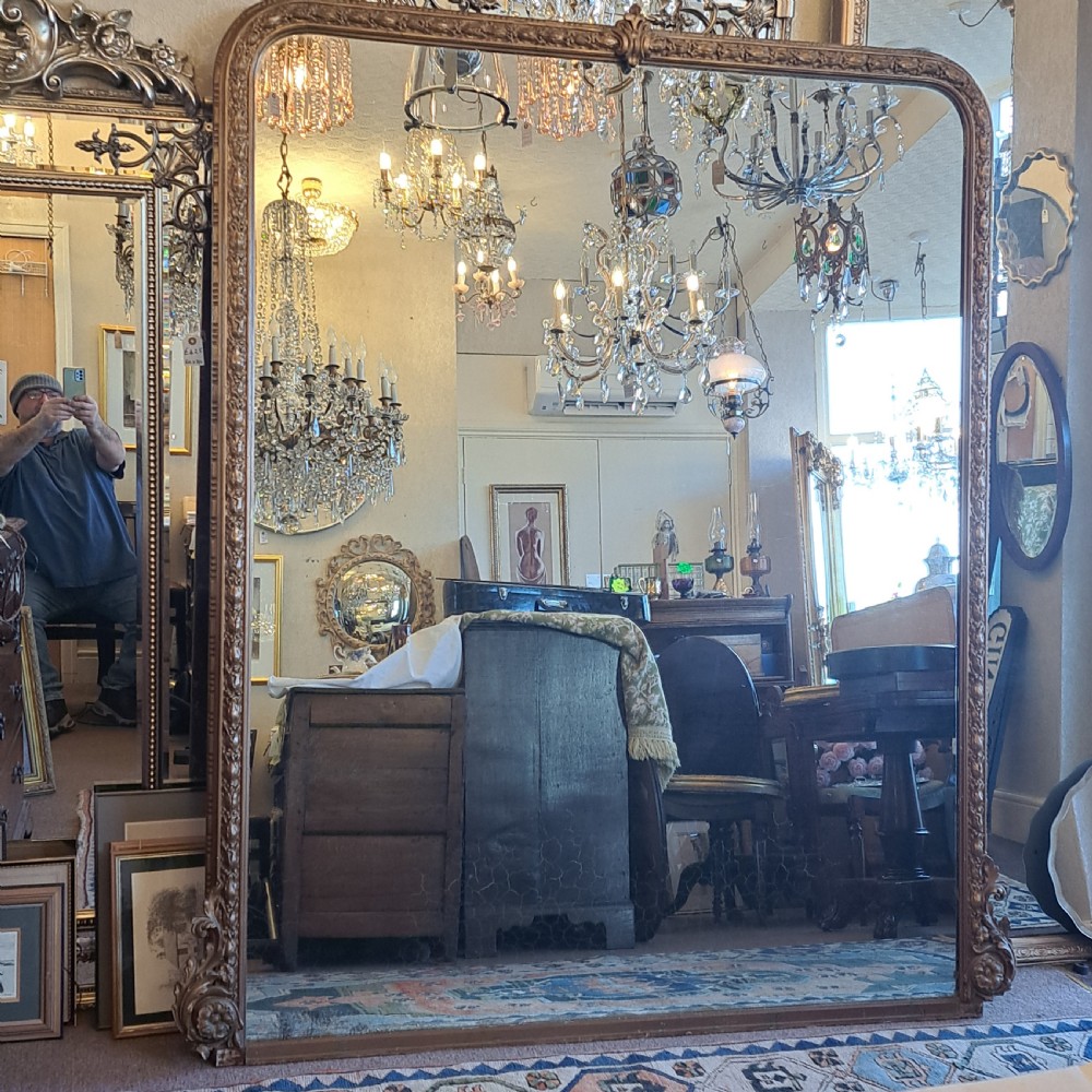 A large rectangular Georgian overmantel mirror featuring a rounded upper frame with gilded bead moulding and decorative foliate corner scrolls. View III