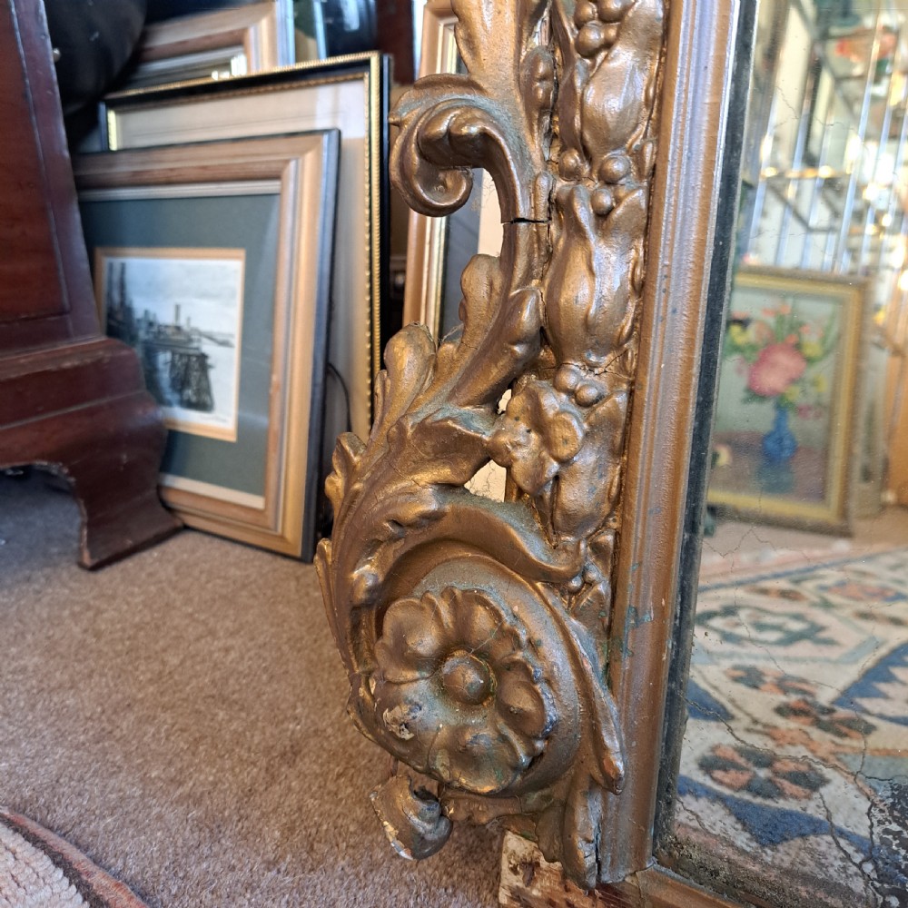 A large rectangular Georgian overmantel mirror featuring a rounded upper frame with gilded bead moulding and decorative foliate corner scrolls. View XI