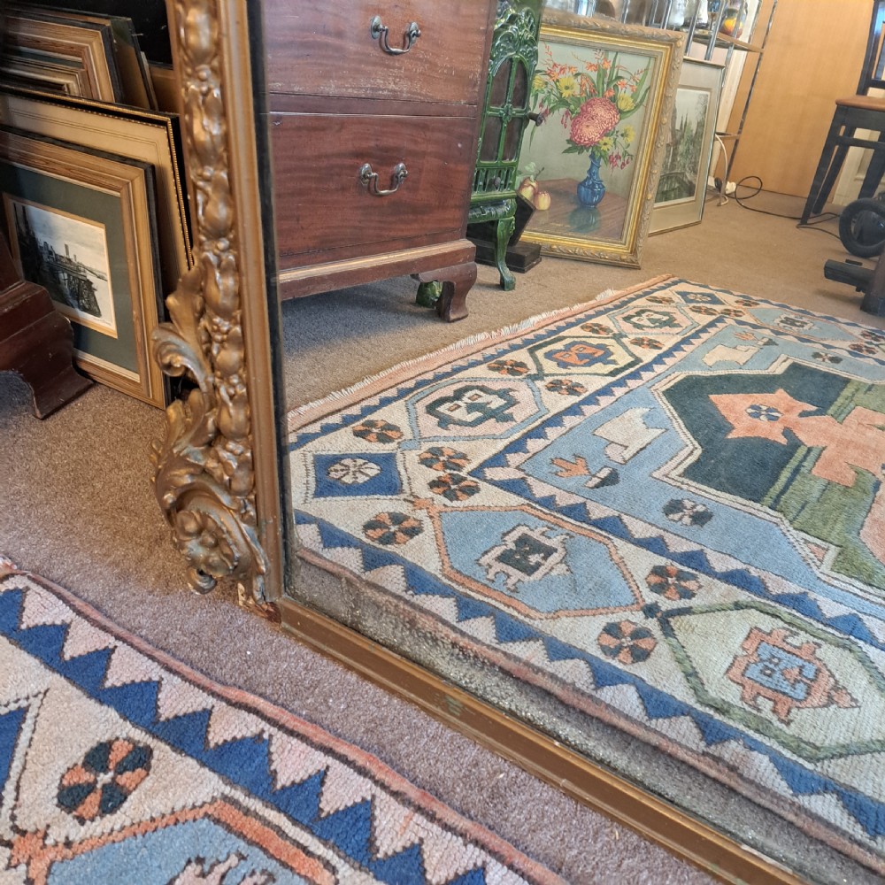 A large rectangular Georgian overmantel mirror featuring a rounded upper frame with gilded bead moulding and decorative foliate corner scrolls. View XIII
