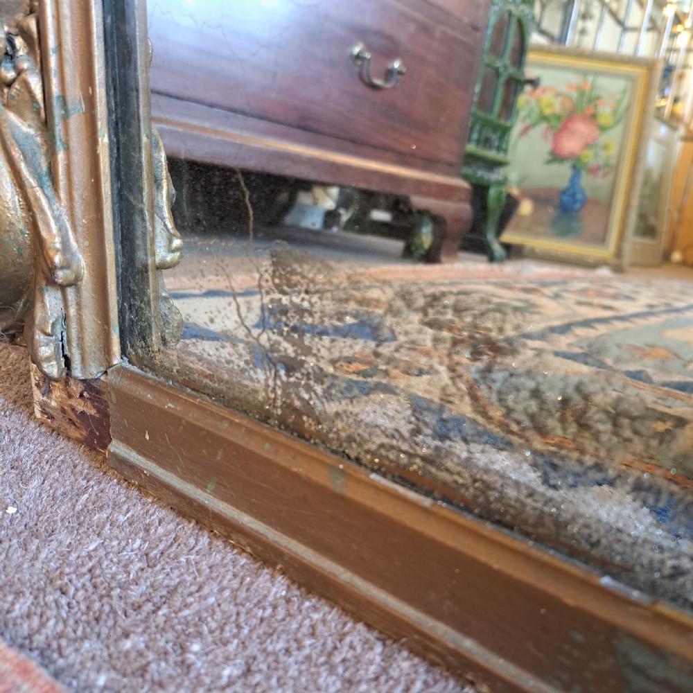 A large rectangular Georgian overmantel mirror featuring a rounded upper frame with gilded bead moulding and decorative foliate corner scrolls. View XIV