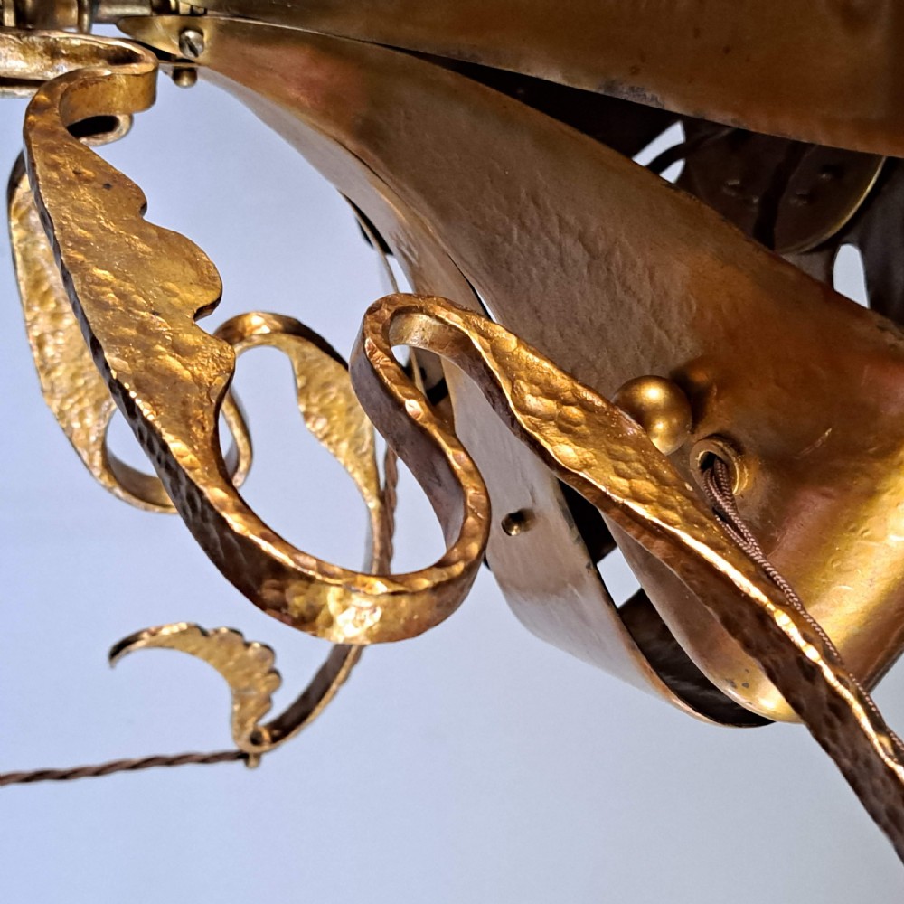 An Arts and Crafts five-light ceiling pendant featuring a beaten copper frame, leaf-scrolled arms, and suspended drop-shaped frosted glass shades. View XIII
