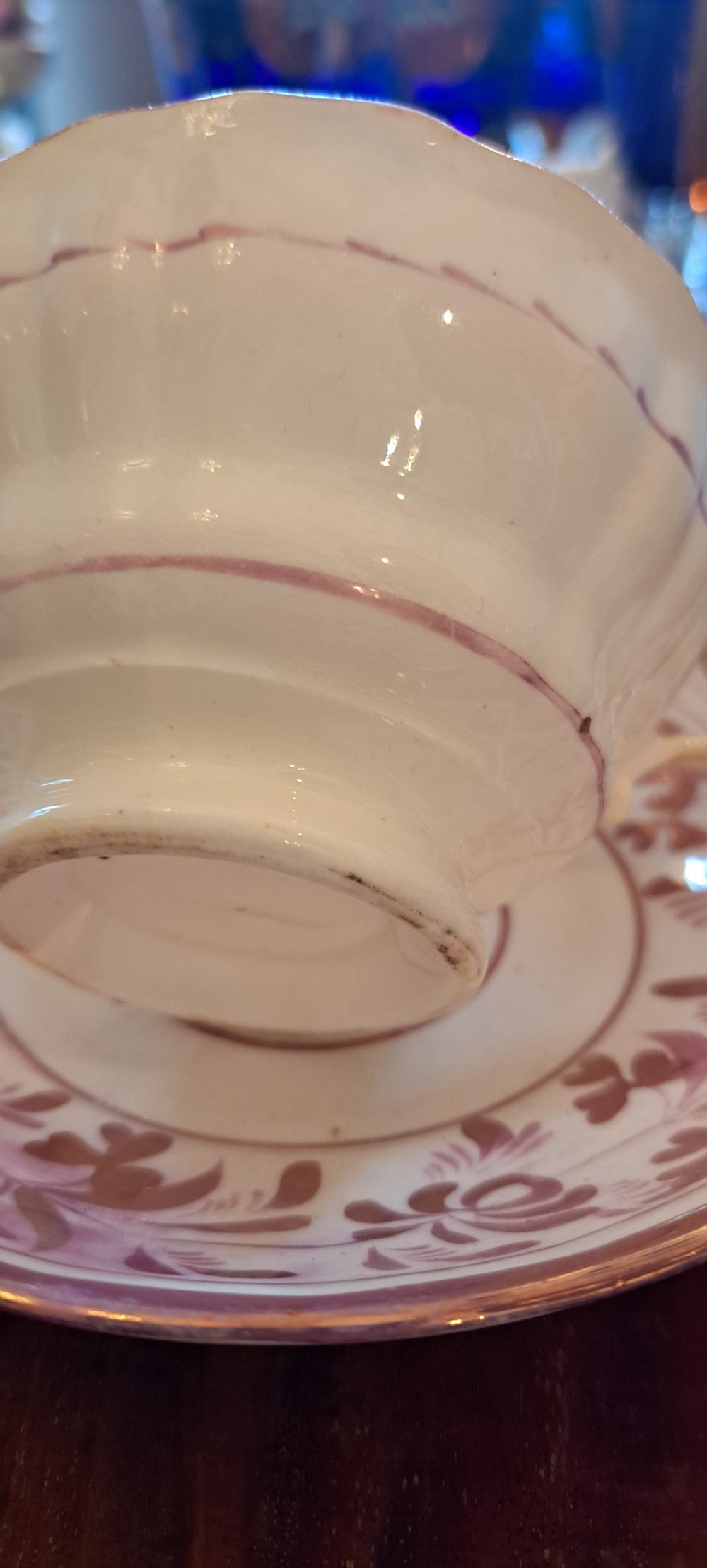 A set of six antique pink lustreware teacups with matching saucers featuring hand-painted botanical foliage patterns on a cream ceramic background. View VI