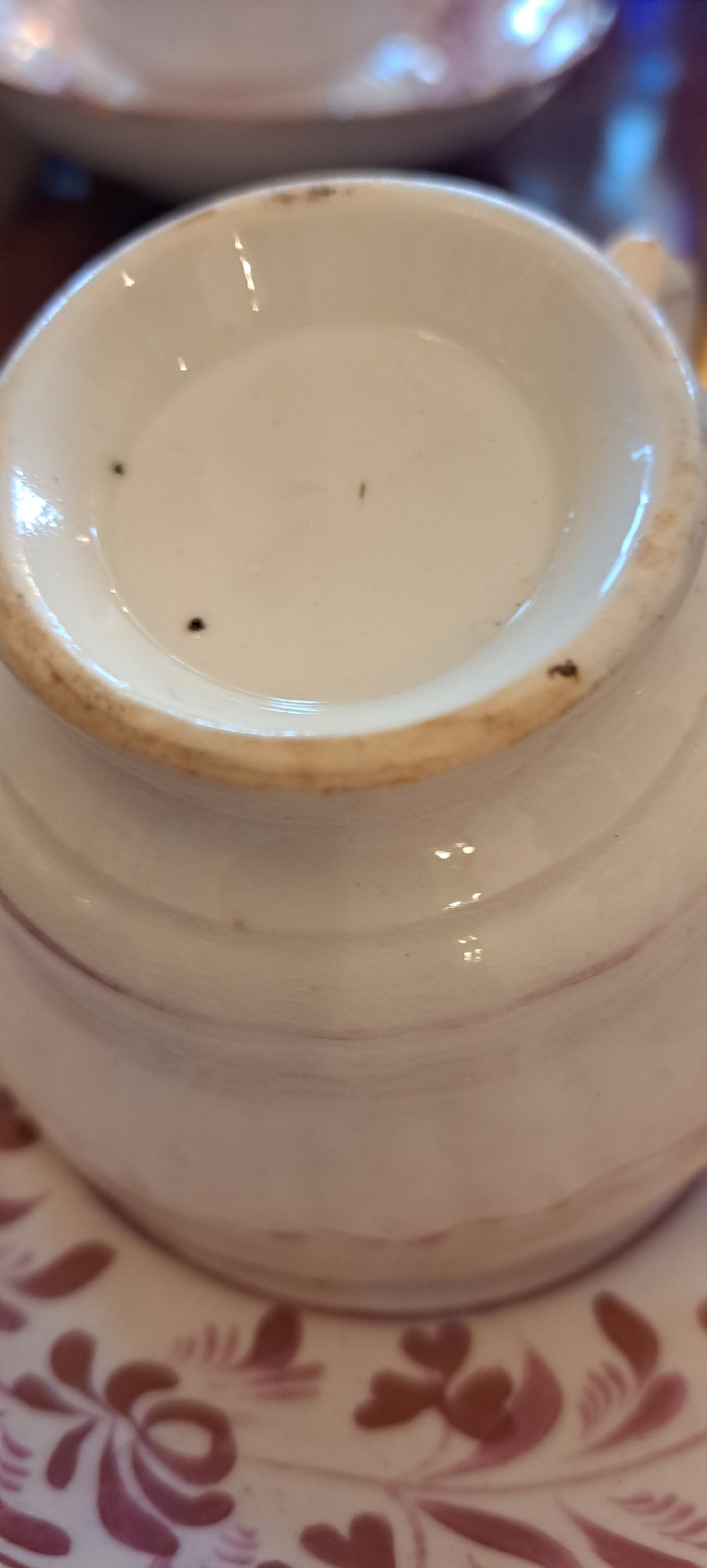 A set of six antique pink lustreware teacups with matching saucers featuring hand-painted botanical foliage patterns on a cream ceramic background. View XV