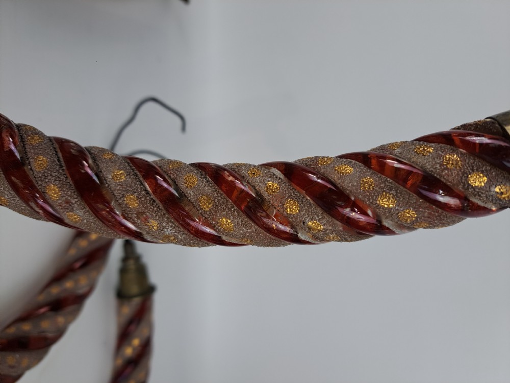 A set of four curved Bohemian ruby glass chandelier arms featuring twisted spiral patterns highlighted with gold enamelled dots and brass threaded mounts. View IV