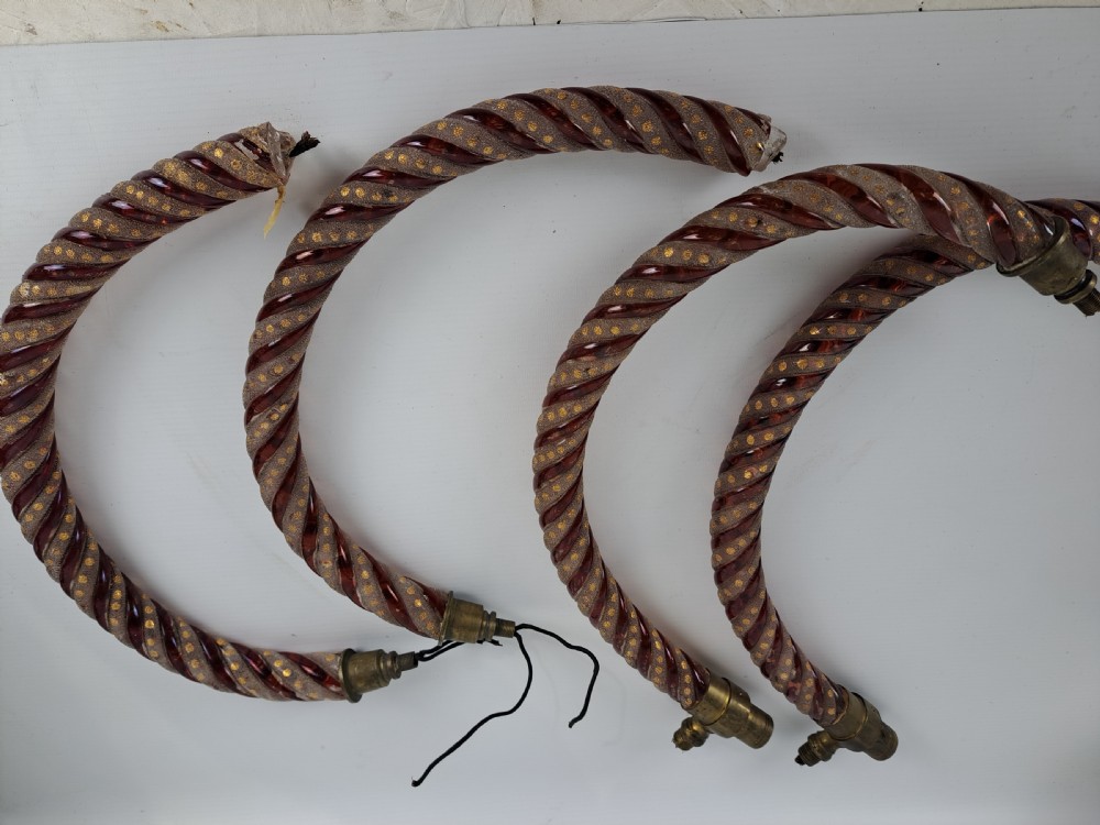A set of four curved Bohemian ruby glass chandelier arms featuring twisted spiral patterns highlighted with gold enamelled dots and brass threaded mounts. View VIII