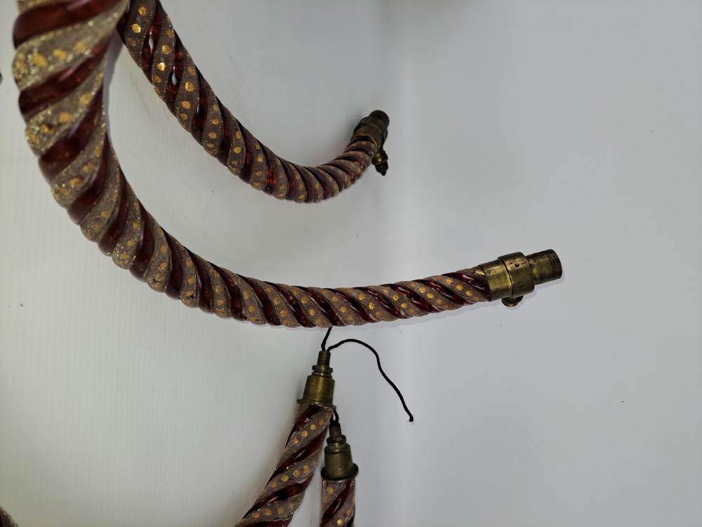 A set of four curved Bohemian ruby glass chandelier arms featuring twisted spiral patterns highlighted with gold enamelled dots and brass threaded mounts. View IX