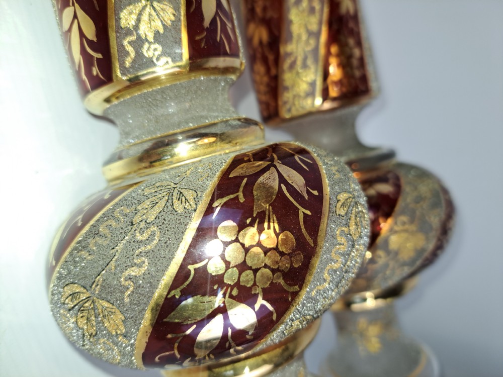 A pair of antique ruby red and frosted glass chandelier stems decorated with spiral gilt grapevine patterns. View III