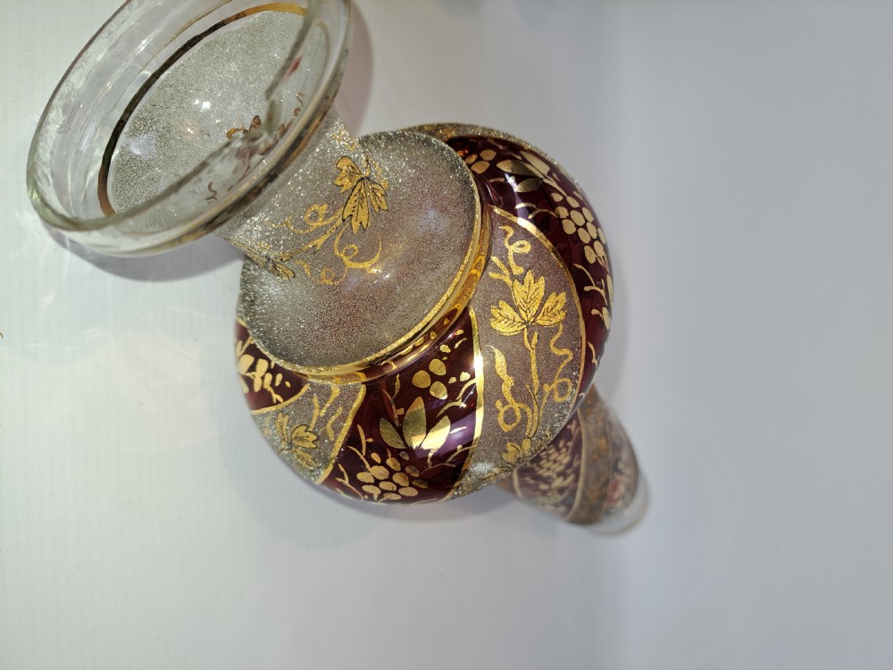 A pair of antique ruby red and frosted glass chandelier stems decorated with spiral gilt grapevine patterns. View V