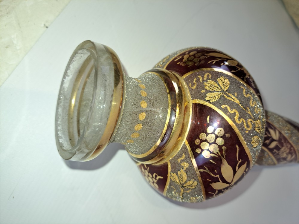 A pair of antique ruby red and frosted glass chandelier stems decorated with spiral gilt grapevine patterns. View X