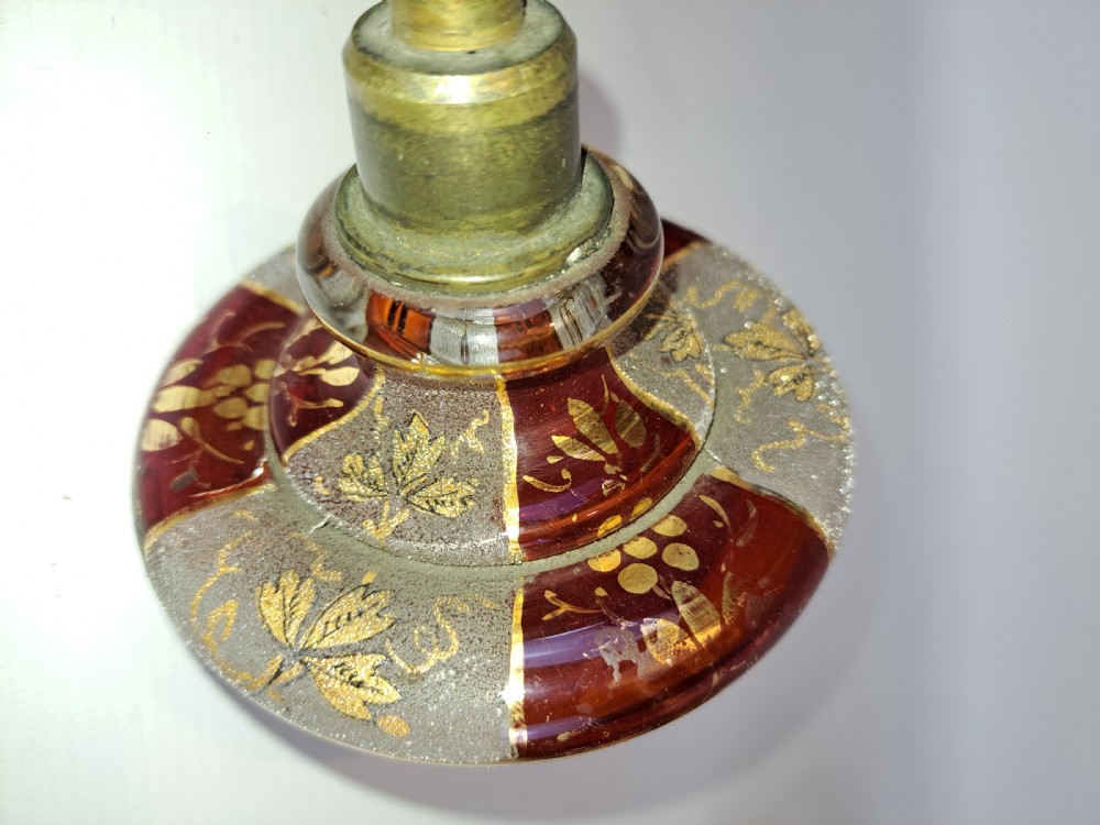 An antique Bohemian ruby glass finial featuring gold leaf floral etching, frosted glass texturing, and a brass threaded mount. View III