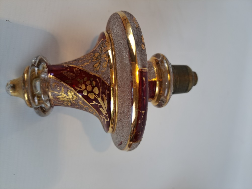 An antique Bohemian ruby glass finial featuring gold leaf floral etching, frosted glass texturing, and a brass threaded mount. View IV