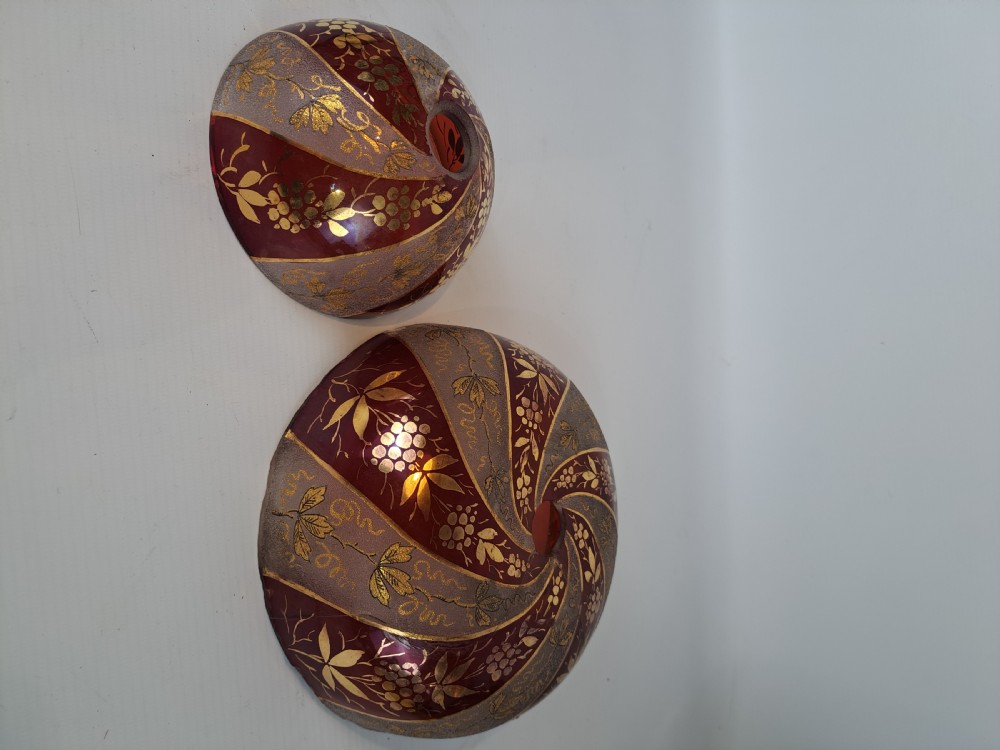 A hemispherical ruby red glass chandelier bowl featuring frosted diagonal panels, gilded grapevine motifs, and a central circular hole. View II