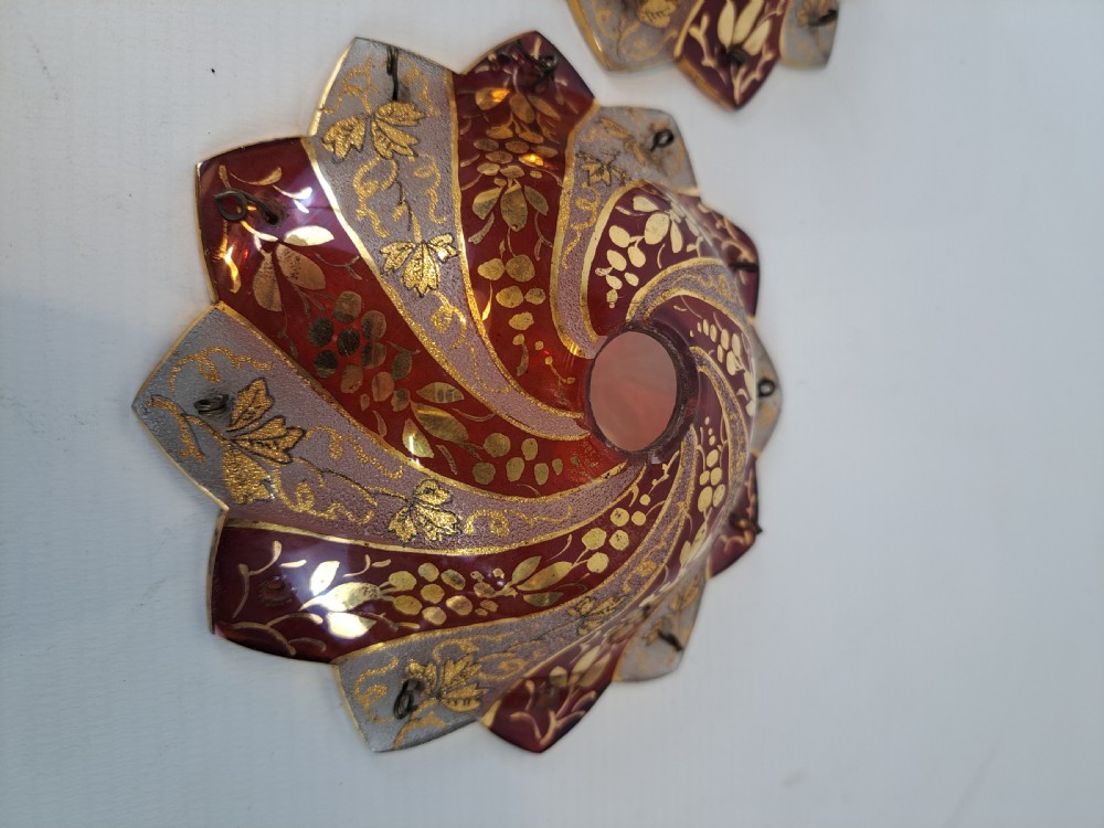 A pair of scalloped Bohemian ruby glass bobeches with frosted panels, hand-painted gold leaf vine patterns, and small metal wire loops. View III