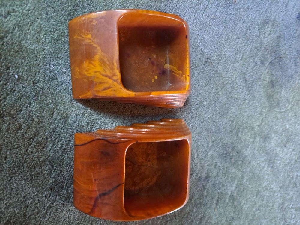 A pair of Art Deco amber phenolic resin stamp wetters featuring stepped side motifs and hollowed rectangular wells. View II