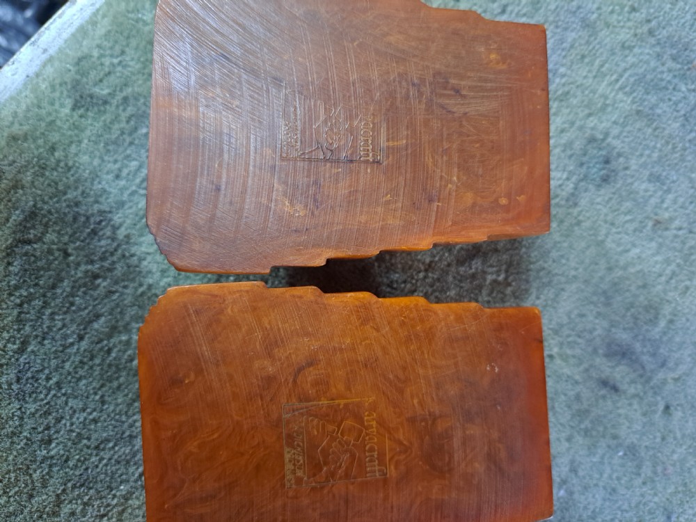 A pair of Art Deco amber phenolic resin stamp wetters featuring stepped side motifs and hollowed rectangular wells. View IV