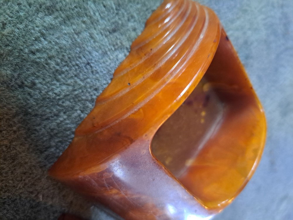 A pair of Art Deco amber phenolic resin stamp wetters featuring stepped side motifs and hollowed rectangular wells. View VIII