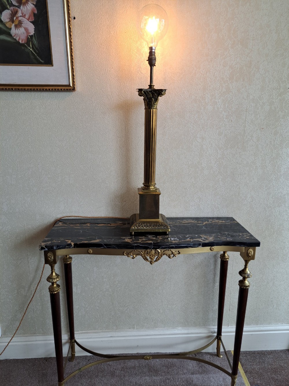 A brass table lamp designed as a classical Corinthian column with a fluted shaft and stepped square base. View II