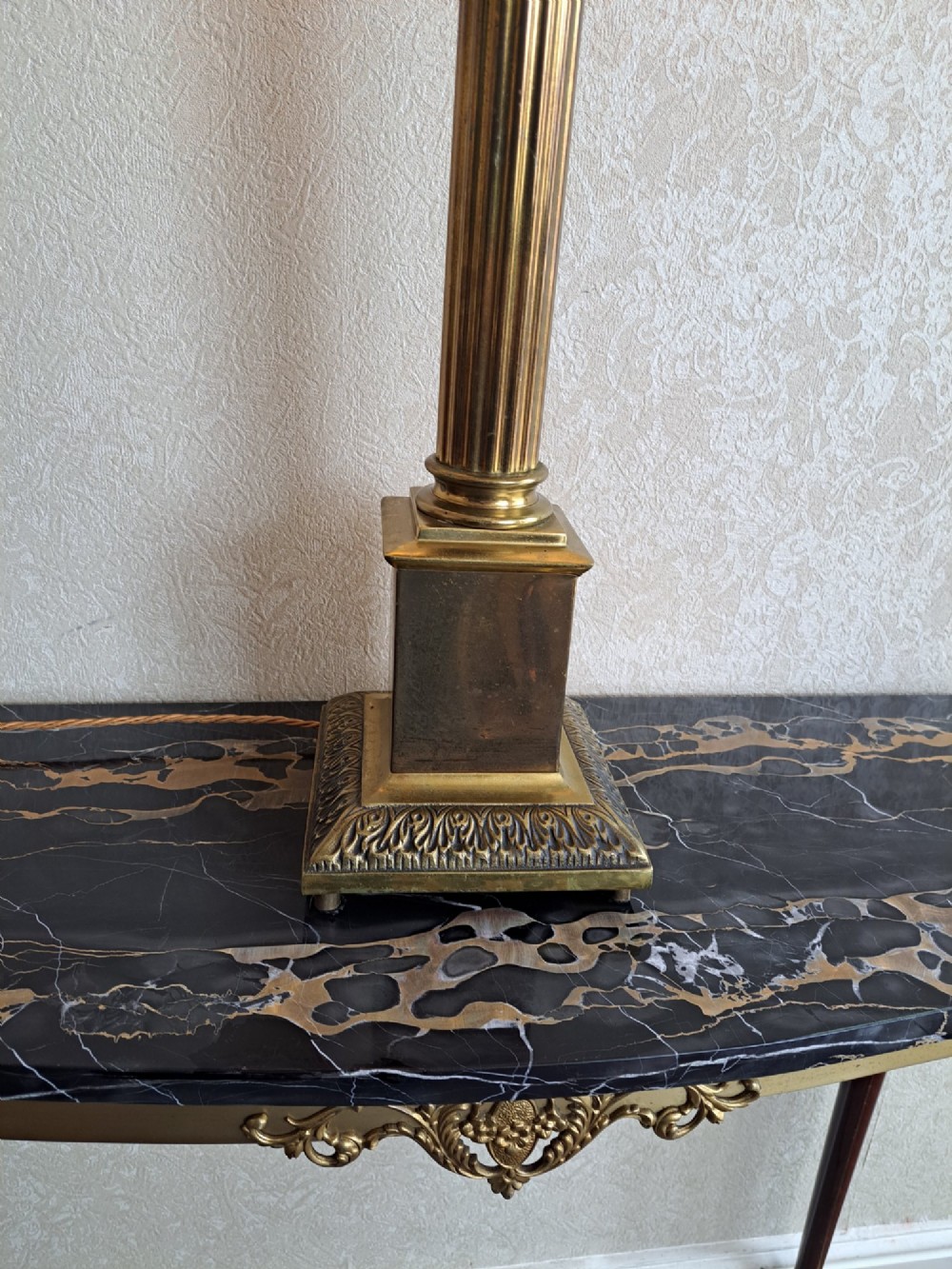 A brass table lamp designed as a classical Corinthian column with a fluted shaft and stepped square base. View III