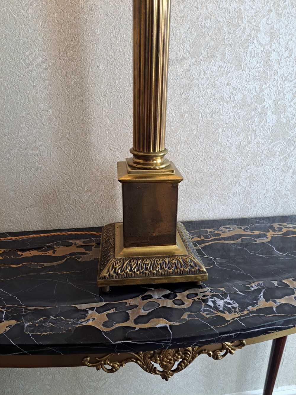 A brass table lamp designed as a classical Corinthian column with a fluted shaft and stepped square base. View IV