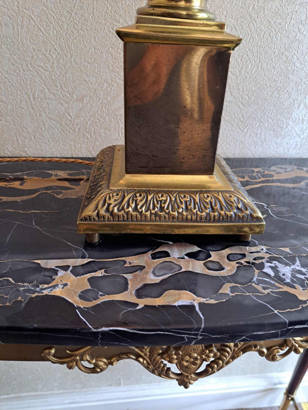 A brass table lamp designed as a classical Corinthian column with a fluted shaft and stepped square base. View V