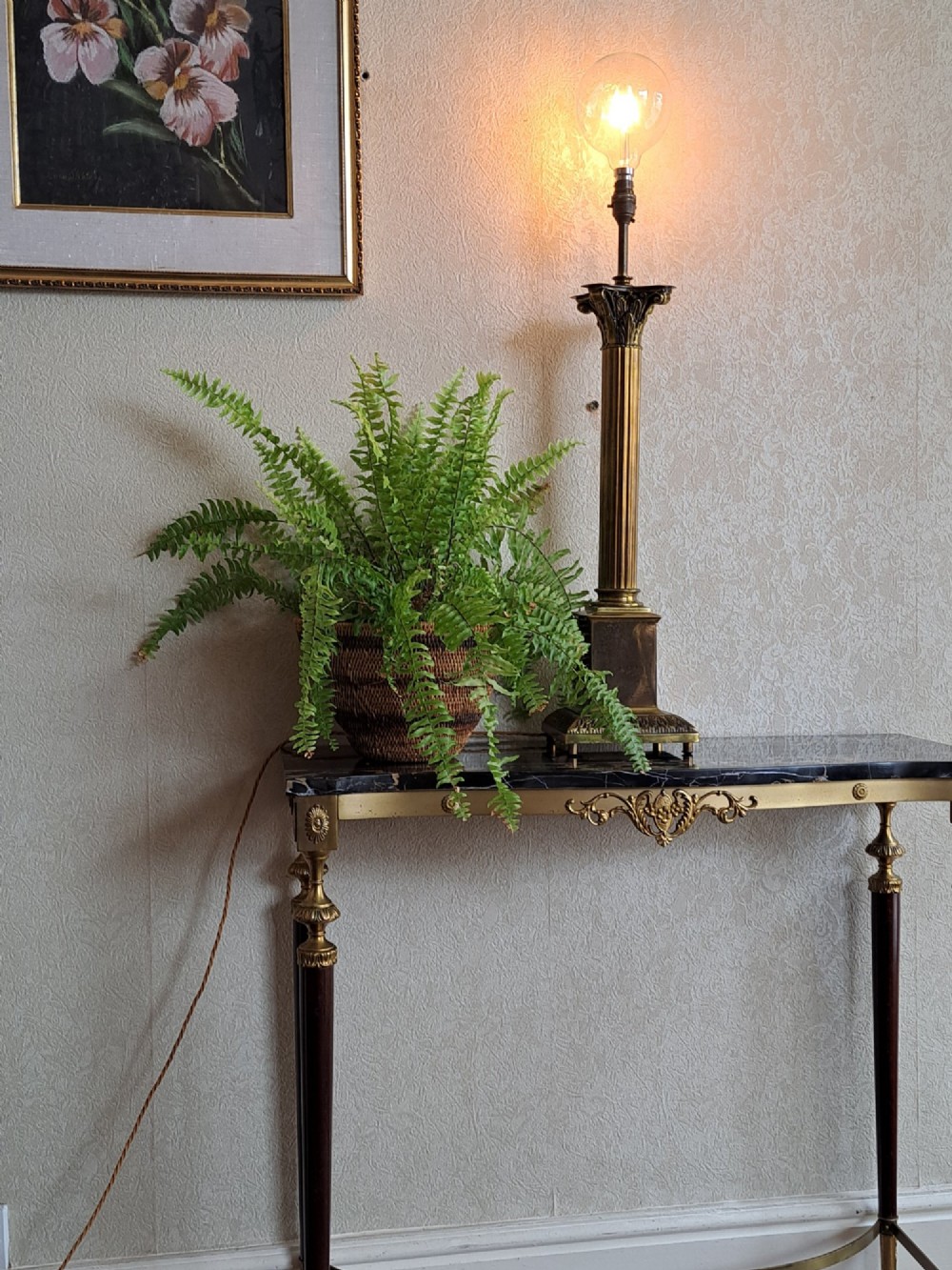 A brass table lamp designed as a classical Corinthian column with a fluted shaft and stepped square base. View VI