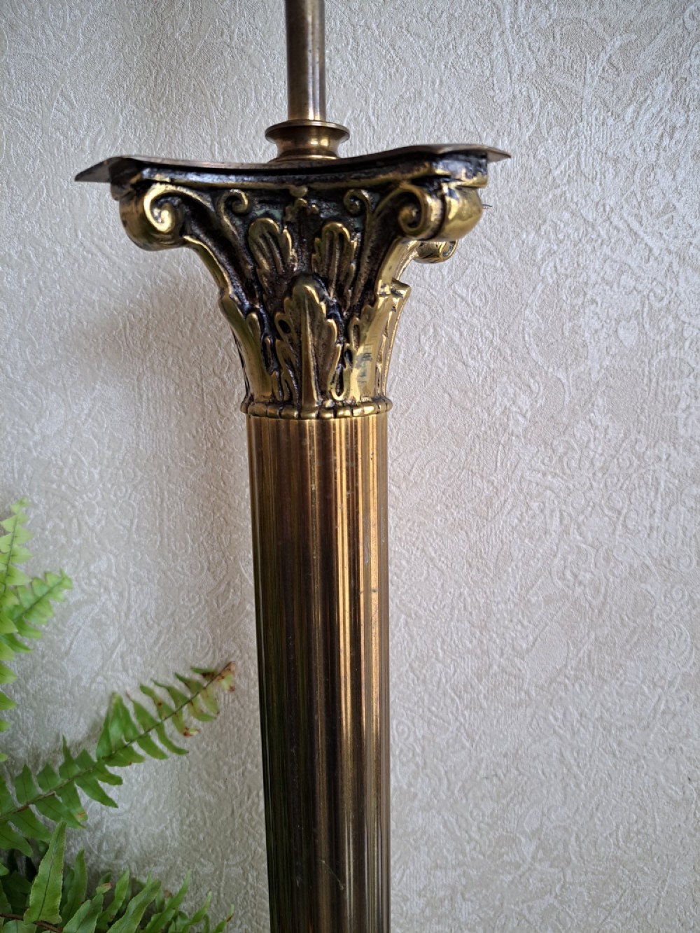 A brass table lamp designed as a classical Corinthian column with a fluted shaft and stepped square base. View VII