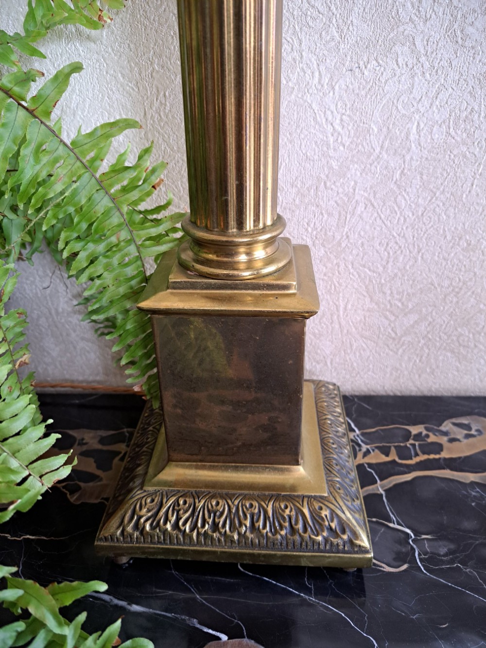 A brass table lamp designed as a classical Corinthian column with a fluted shaft and stepped square base. View VIII