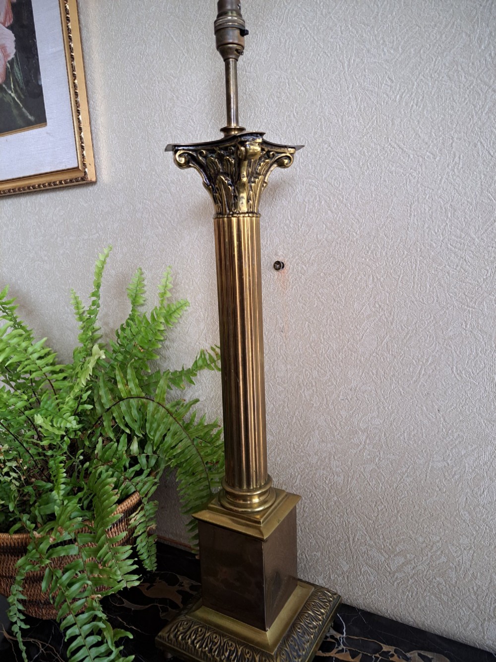 A brass table lamp designed as a classical Corinthian column with a fluted shaft and stepped square base. View X