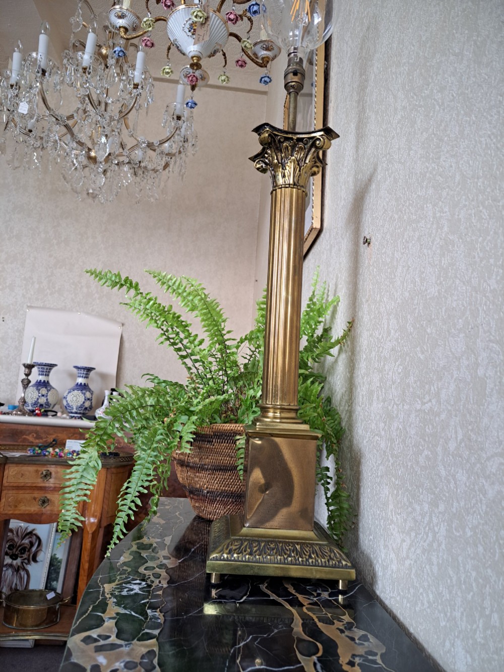 A brass table lamp designed as a classical Corinthian column with a fluted shaft and stepped square base. View XII
