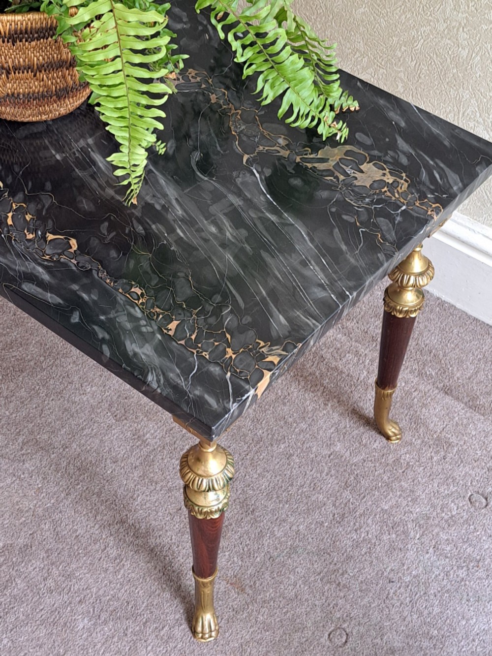 A rectangular coffee table featuring a dark veined marble top supported by tapered legs with ornamental brass mounts and brass feet. View II