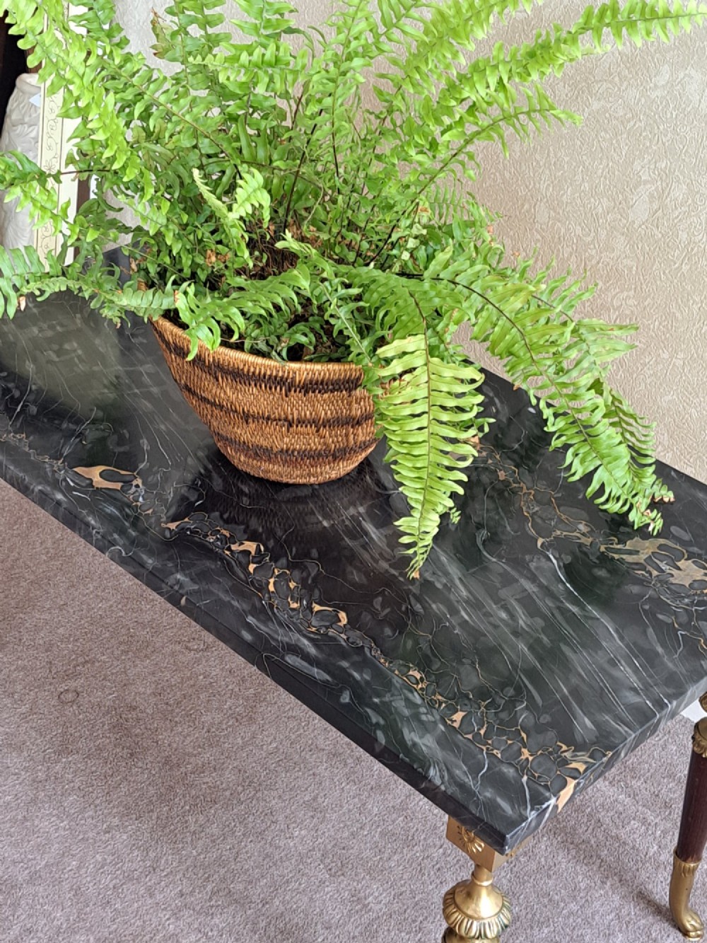 A rectangular coffee table featuring a dark veined marble top supported by tapered legs with ornamental brass mounts and brass feet. View III