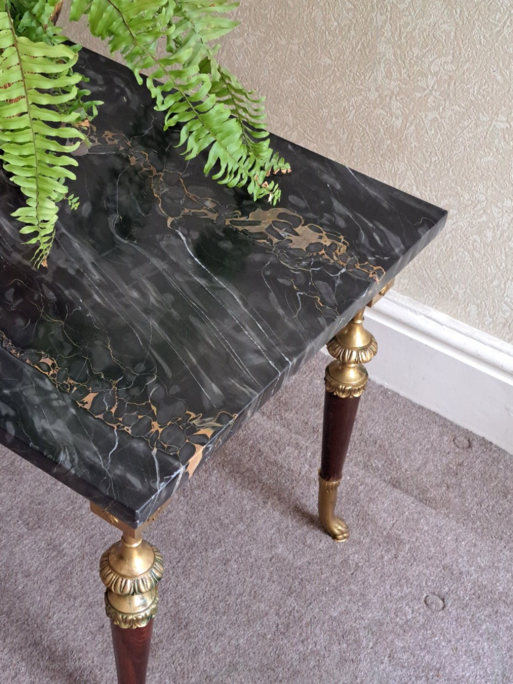 A rectangular coffee table featuring a dark veined marble top supported by tapered legs with ornamental brass mounts and brass feet. View IV