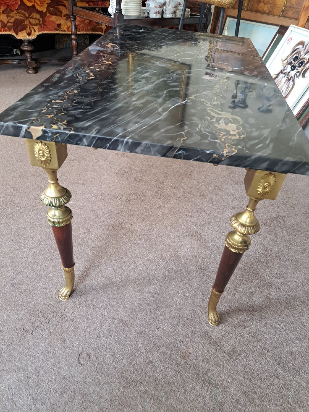 A rectangular coffee table featuring a dark veined marble top supported by tapered legs with ornamental brass mounts and brass feet. View XI