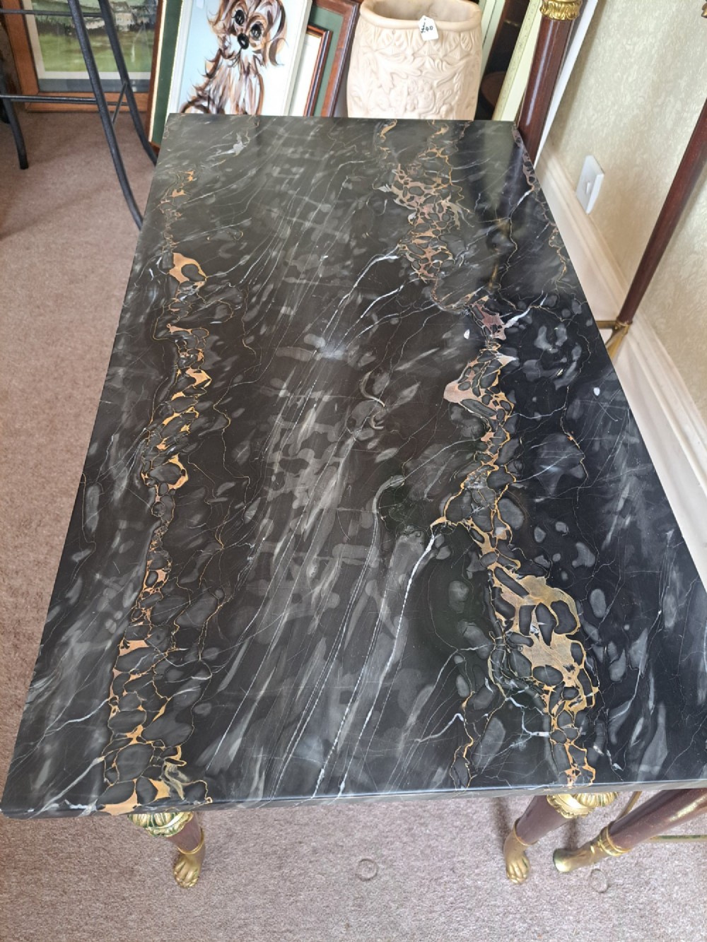 A rectangular coffee table featuring a dark veined marble top supported by tapered legs with ornamental brass mounts and brass feet. View XII