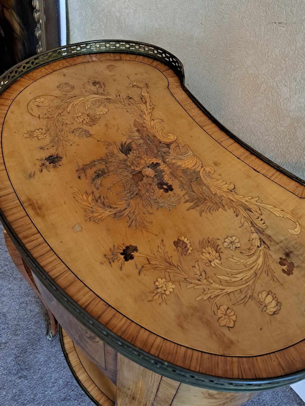 A kidney-shaped French marquetry side table featuring floral timber inlays, two drawers, a pierced brass gallery top, and a lower shelf. View II