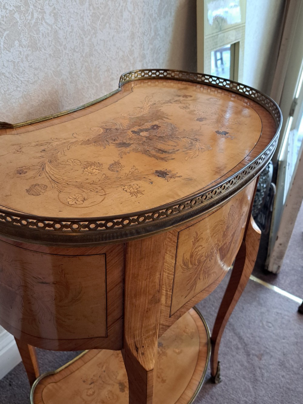 A kidney-shaped French marquetry side table featuring floral timber inlays, two drawers, a pierced brass gallery top, and a lower shelf. View III