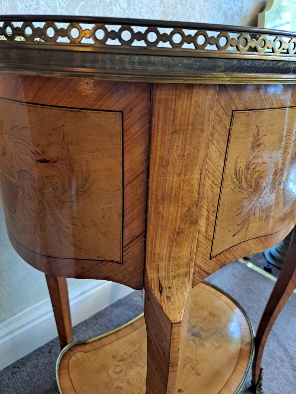 A kidney-shaped French marquetry side table featuring floral timber inlays, two drawers, a pierced brass gallery top, and a lower shelf. View VI