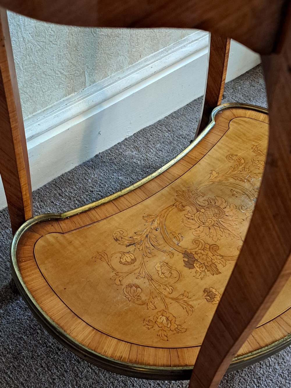A kidney-shaped French marquetry side table featuring floral timber inlays, two drawers, a pierced brass gallery top, and a lower shelf. View VII