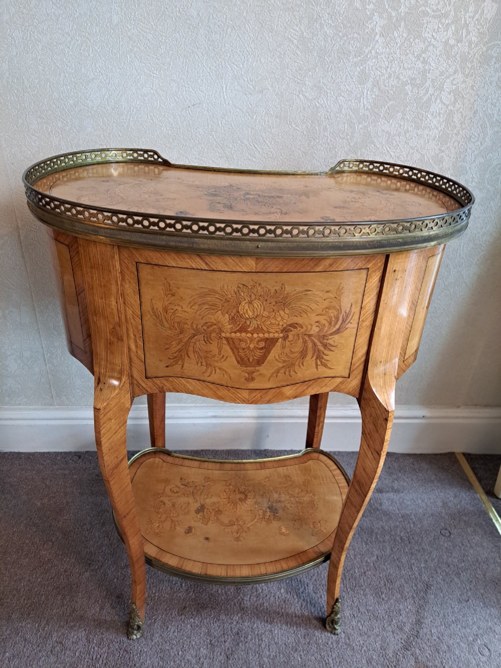 A kidney-shaped French marquetry side table featuring floral timber inlays, two drawers, a pierced brass gallery top, and a lower shelf. View XI