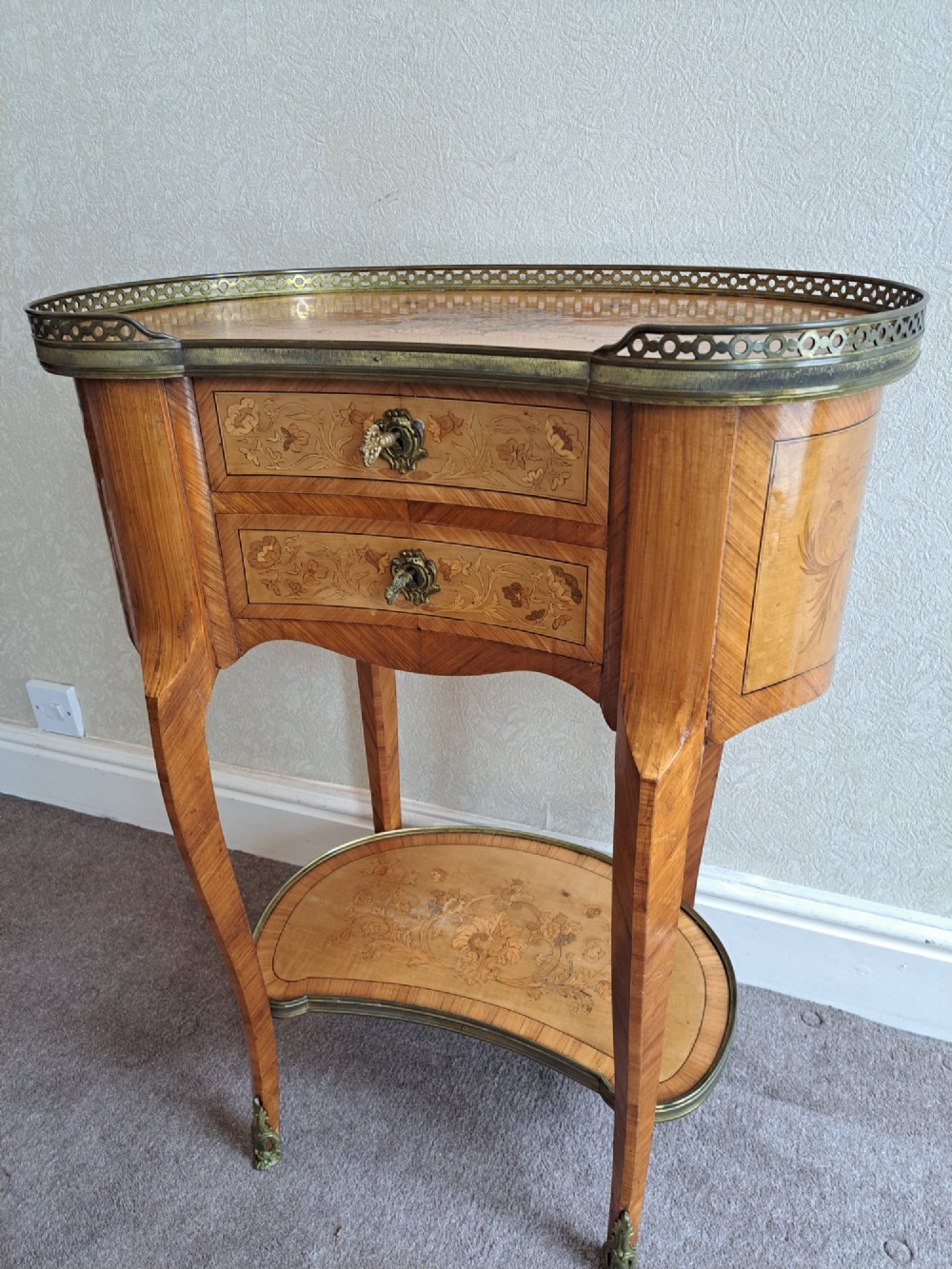 A kidney-shaped French marquetry side table featuring floral timber inlays, two drawers, a pierced brass gallery top, and a lower shelf. View XIV