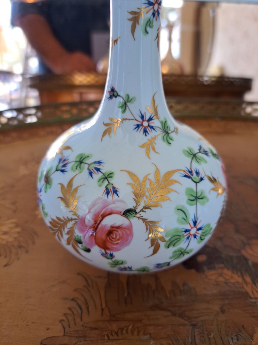 A pair of white porcelain bud vases featuring hand-painted floral motifs in pink, blue, and green with gilded rims and leaf accents. View VIII