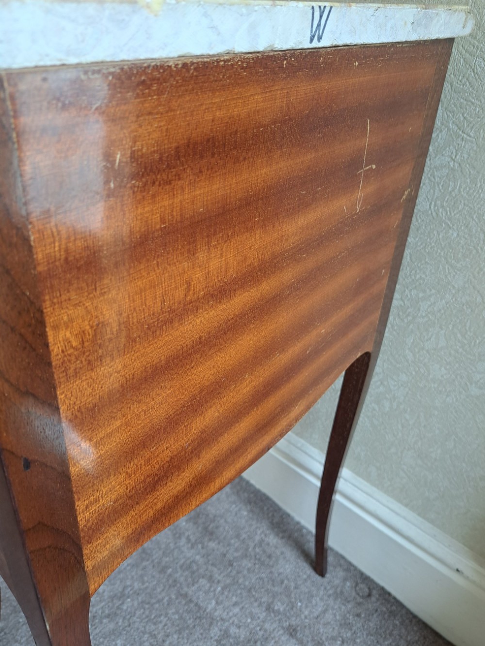 A pair of French style bedside tables featuring contoured beige marble tops, floral marquetry veneer drawers, brass handles, and sweeping cabriole legs. View XV