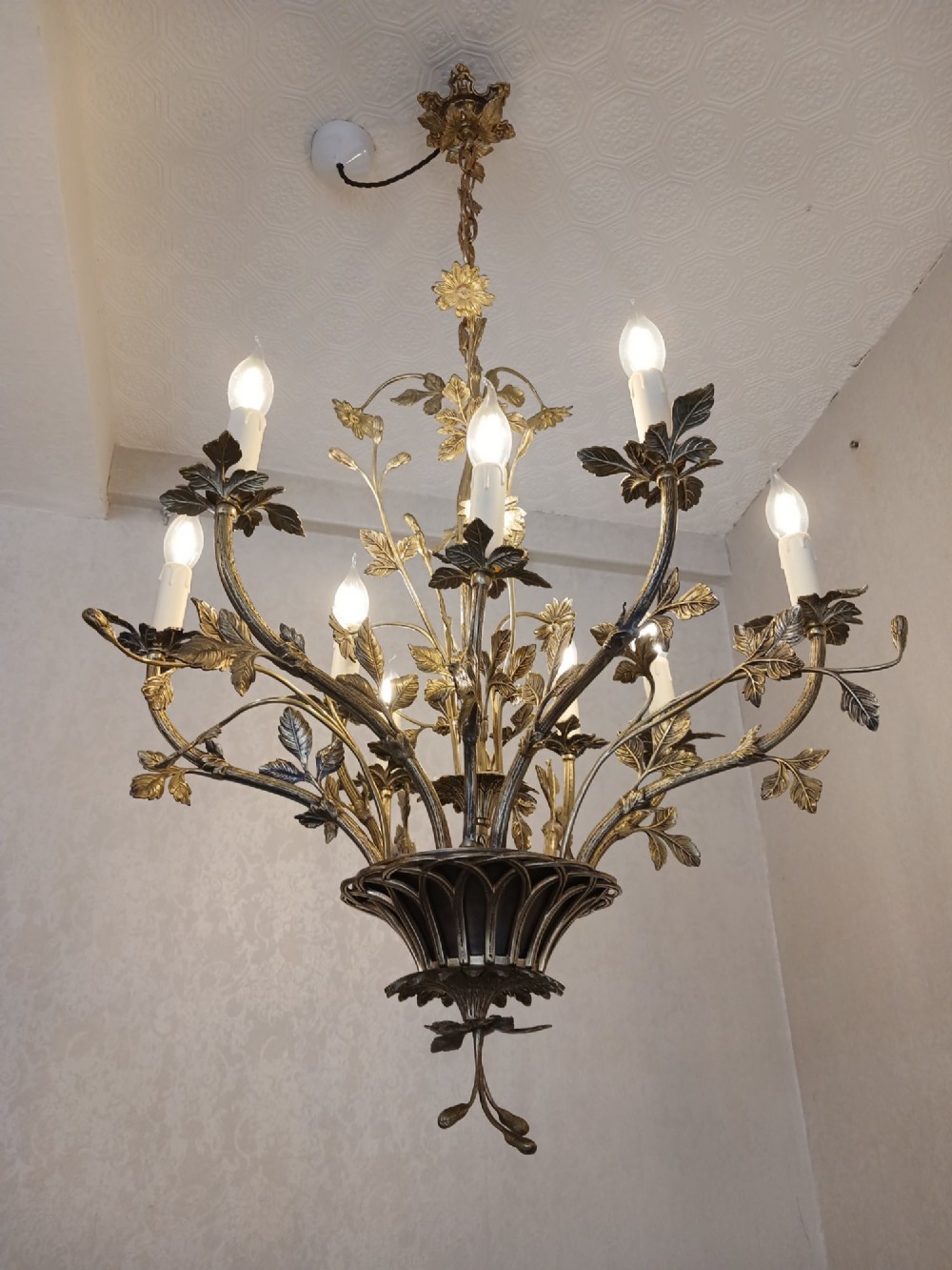 A French gilt bronze chandelier featuring leaf and floral motifs arranged in a basket form with candle bulb sockets.